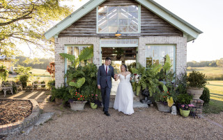 Bride and groom portrait in front of West Milford Farm greenhouse